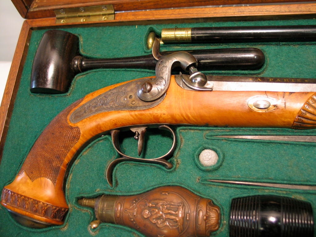 An exceptionally fine example of mid nineteenth century French percussion dueling pistols presented in the original fitted walnut box. These high quality pistols are in excellent condition. Each pistol has a wonderful rich burl maple color stock and