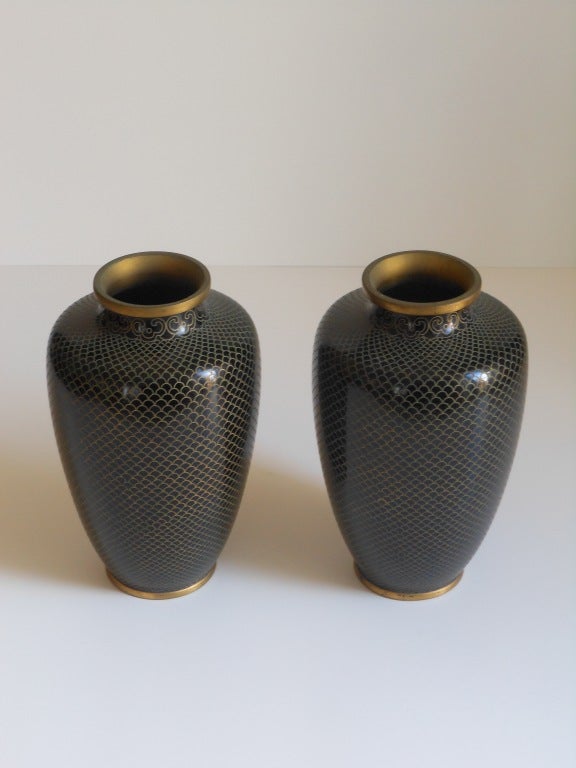 Classic and gorgeous pair of chinese cloisonne vases with a patinated brass rim and base. Interior has the blue patina. Classic gold fish scale pattern over a black base.