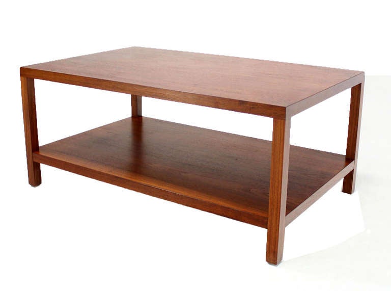 Very nice mid-century modern parson's style walnut table with bottom shelf.