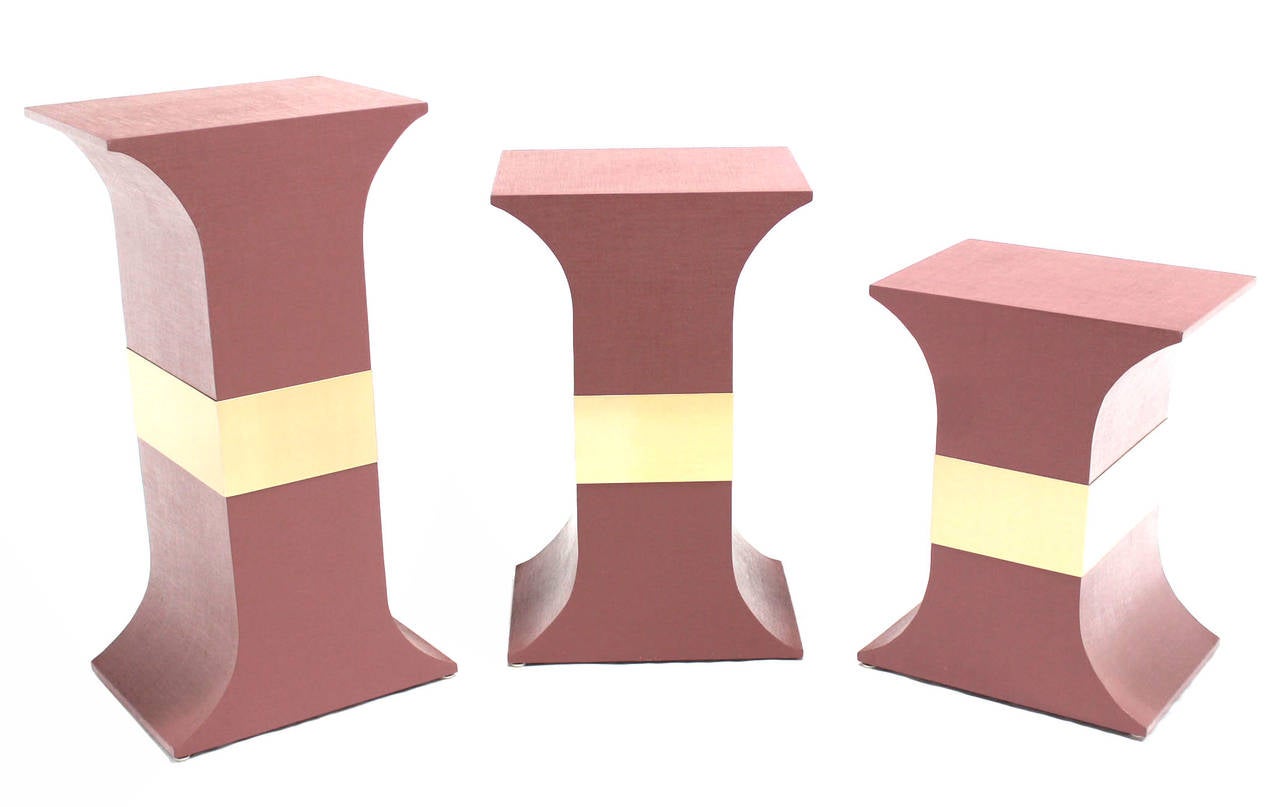 Set of three matching pedestals wrapped in grass cloth in style of Springer. Dimensions: 20x15x38, 20x15x32, 20x15x26
