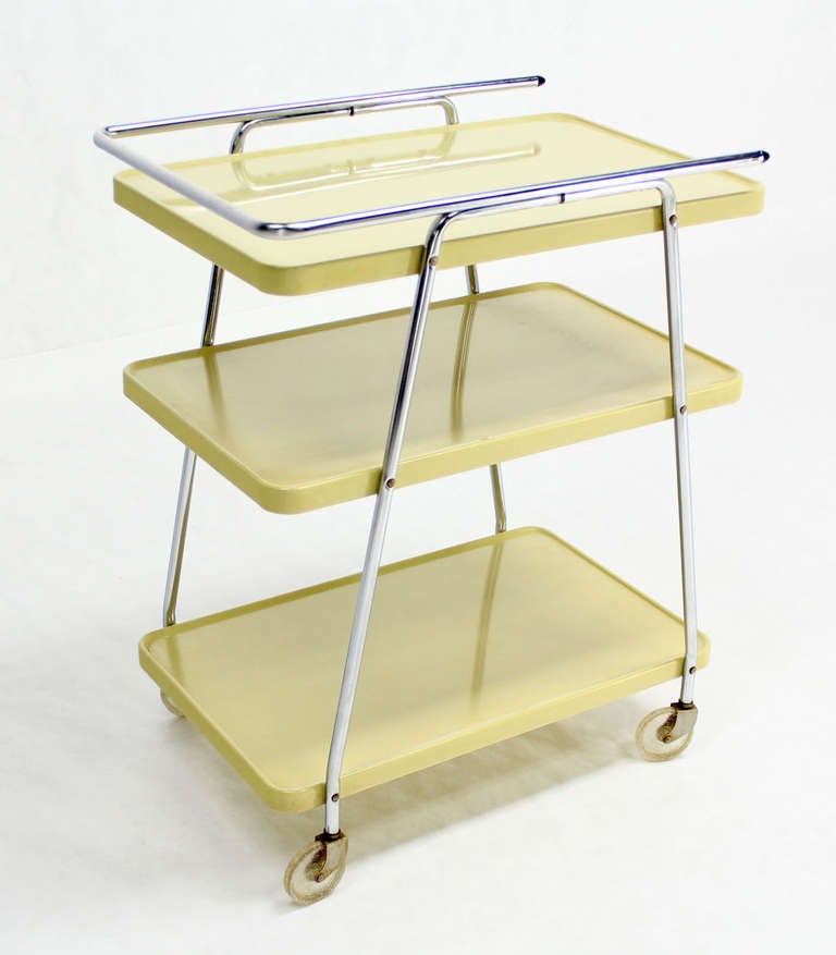 Nice enameled formed sheet metal design serving cart from circa 1950s era.