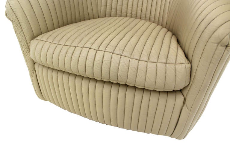 Pair of nice swivel M. Baughman design lounge chairs upholstered in beige ribbed leather. 