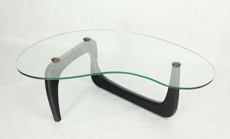 Very nice organic shape mid century modern table with solid brass lags to hold the glass in place.