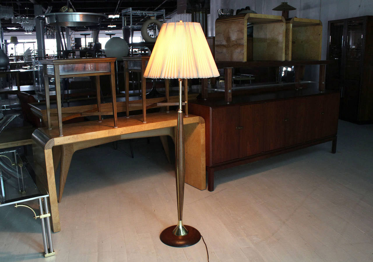 Solid sculpted walnut strips and base inland with brass mid-century modern floor lamp.