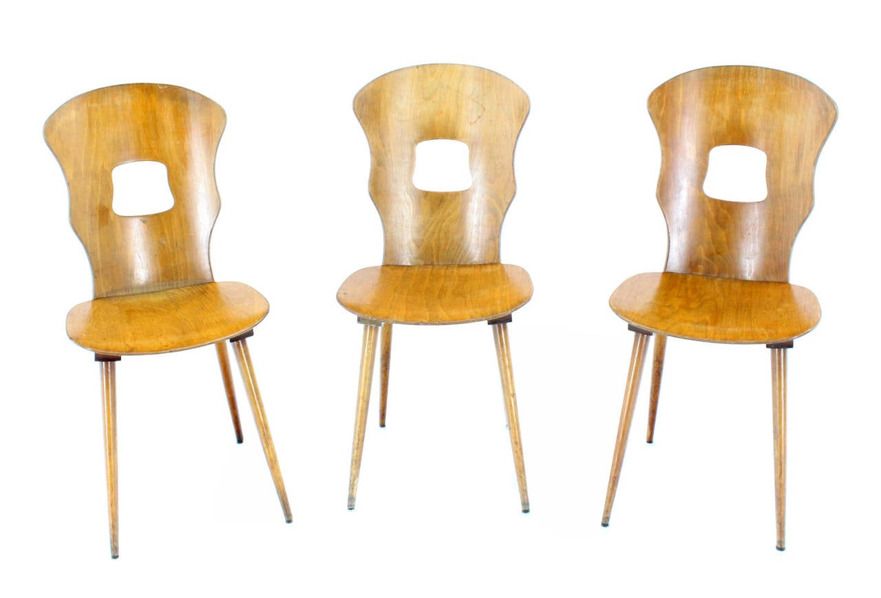 Set of three unusual molded plywood dining chairs.