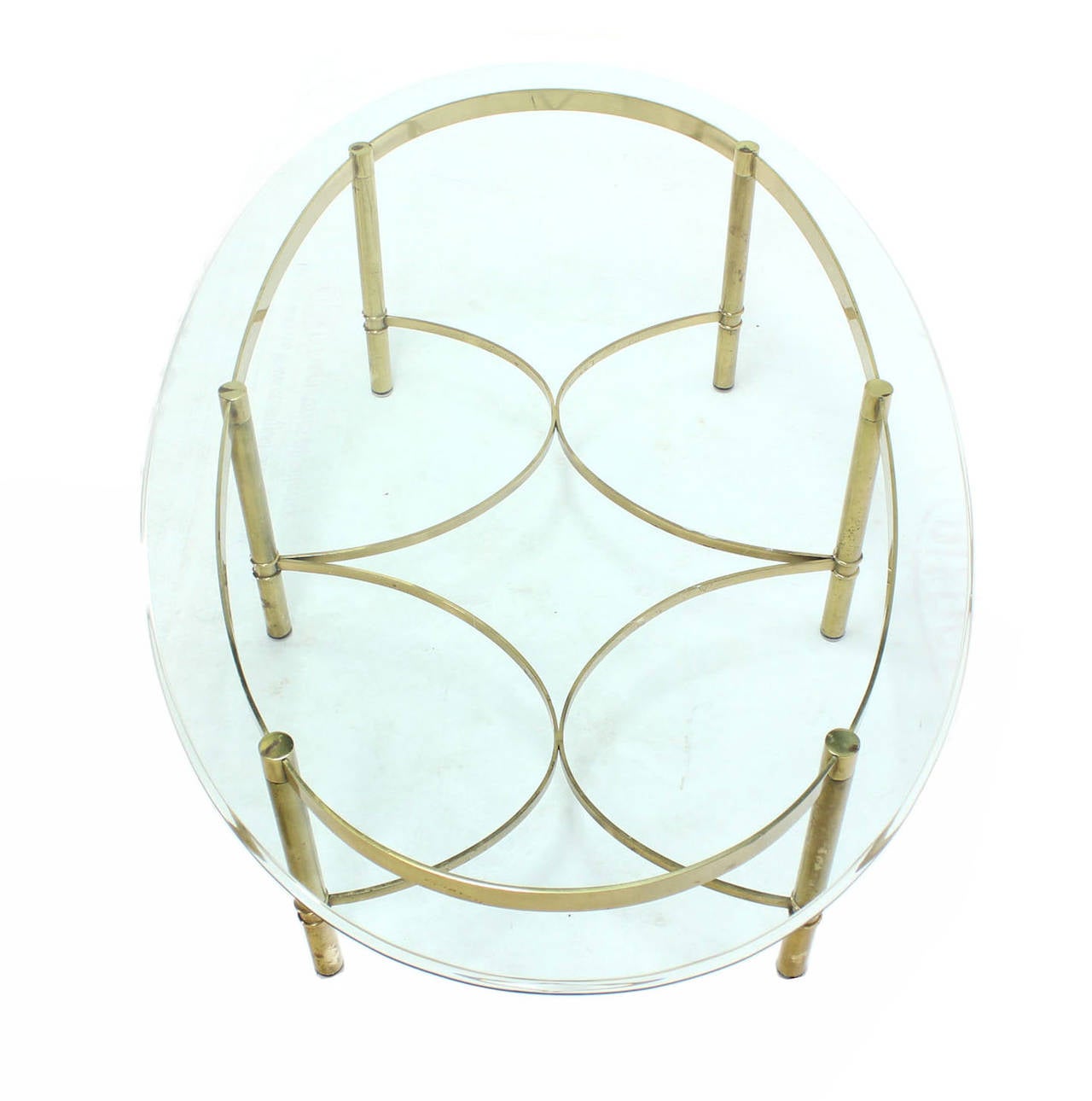 Mid-century modern oval brass and glass coffee table.