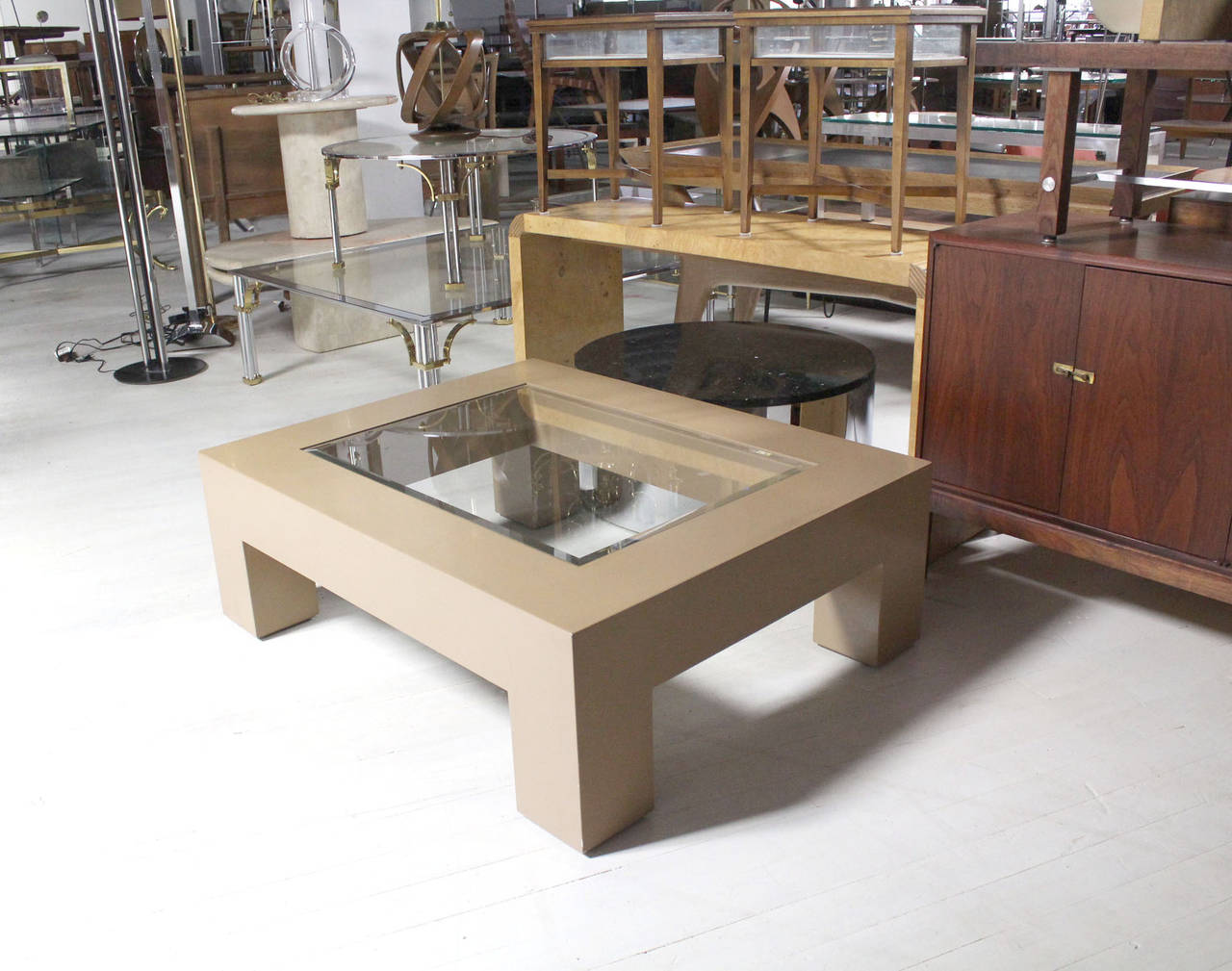 Nice mid century modern beige lacquered base coffee table in style of M. Baughman. Heavy square legs. Nice center statement piece.