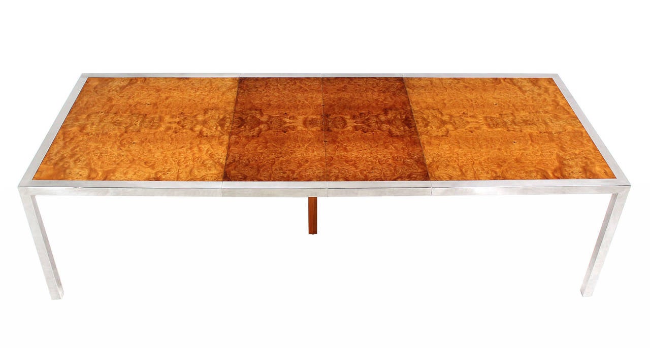 Nice polished stainless steel frame with burl wood top mid  century dining table. The  two 18x42 leaves are slightly darker then the rest of the table. Full price includes refinishing job necessary to match the leaves to the rest of the table.