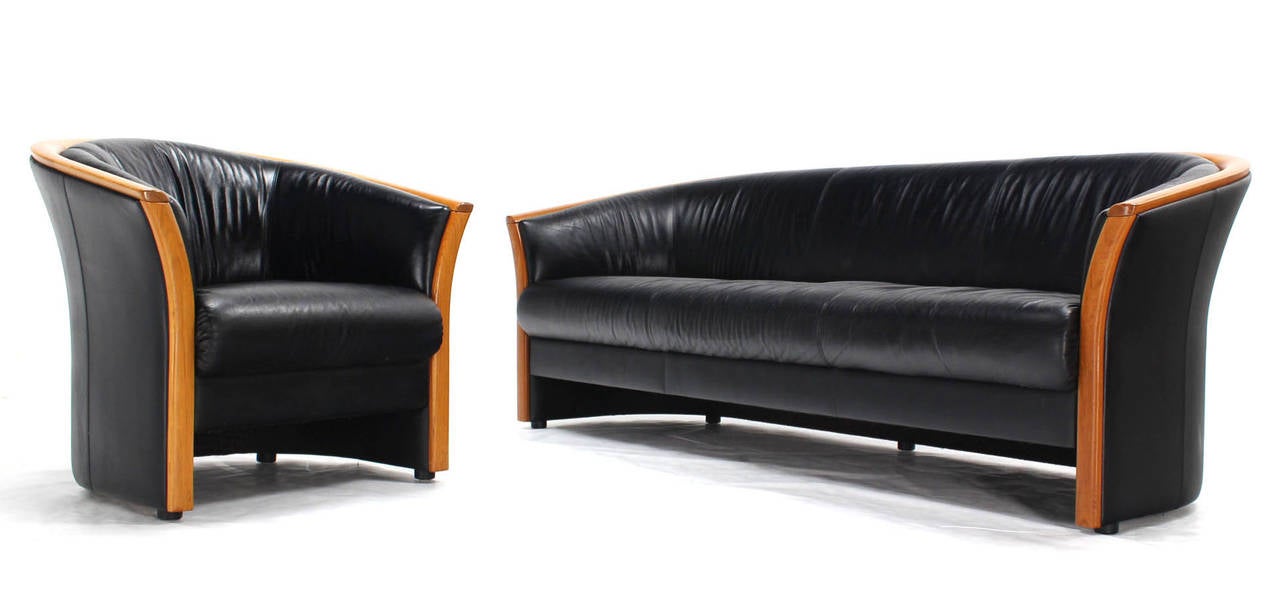Beautiful set of black leather sofa and barrel back armchair. Nice curved shape design. The chair measures 33 x 31 x 31.