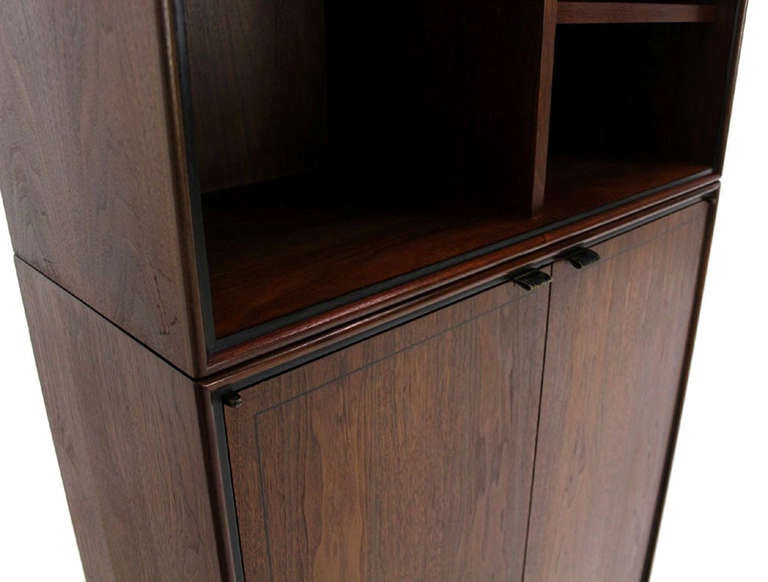 Nice 2 part walnut cabinet with leather pulls. Good craftsmanship quality piece.
