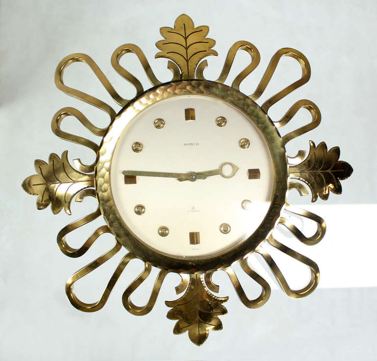 Nice mid century solid bronze swiss sunburst clock. Easy pull to wind up string mechanism.