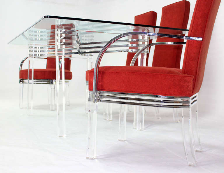 glass dining table with red chairs
