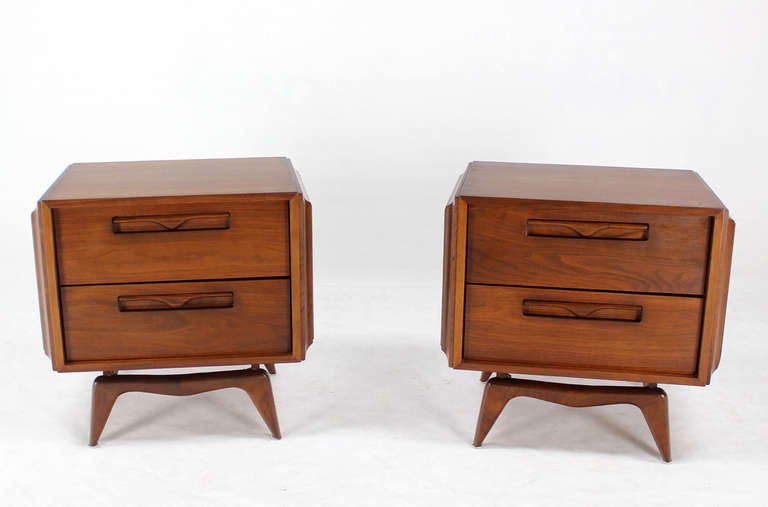 Pair of nice solid built walnut nightstands on sculptural solid walnut legs.
