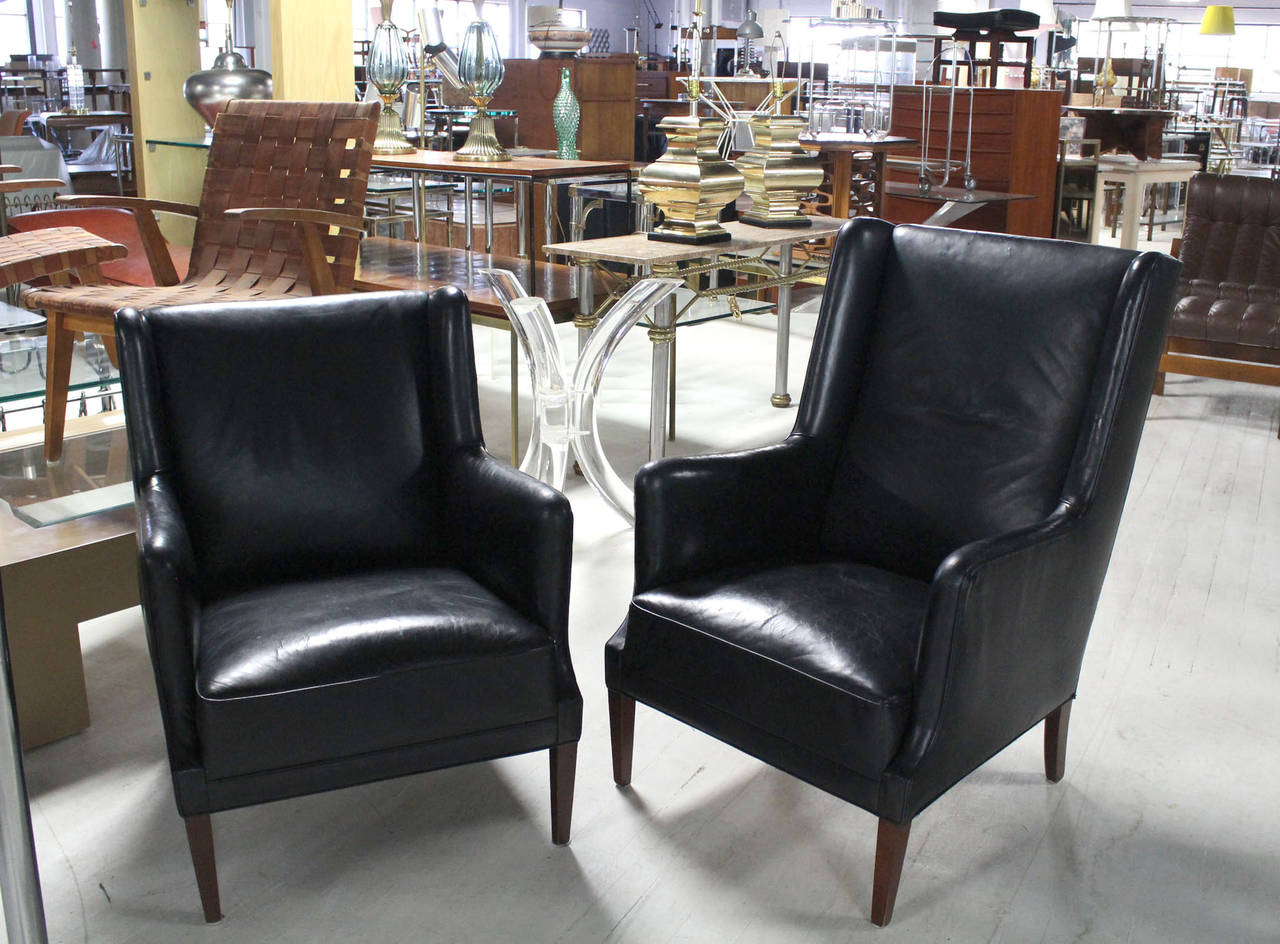 Pair of high quality leather upholstered  modern wing chairs. These chairs feature very comfortable spring loaded seats not PU foam seats.
26x28x33 - second chair