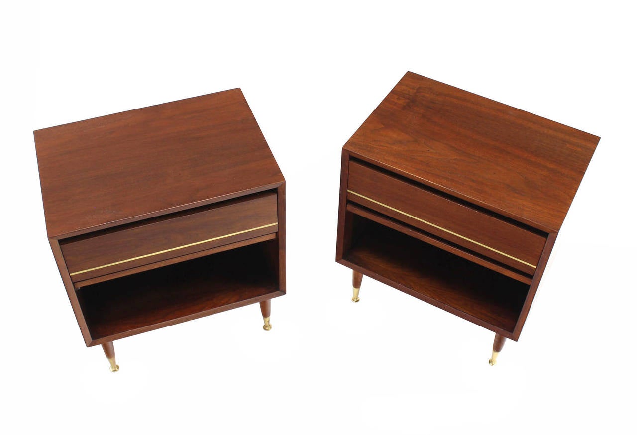 Pair of danish modern walnut night stands with brass inlay and legs tops.
Nice clean cube shape cabinets.