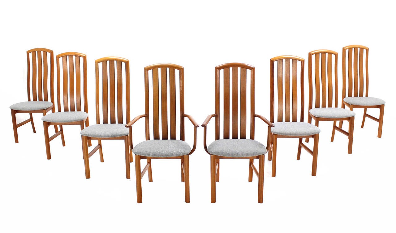 Set of eight newly upholstered in thick wool fabric teak Danish chairs.