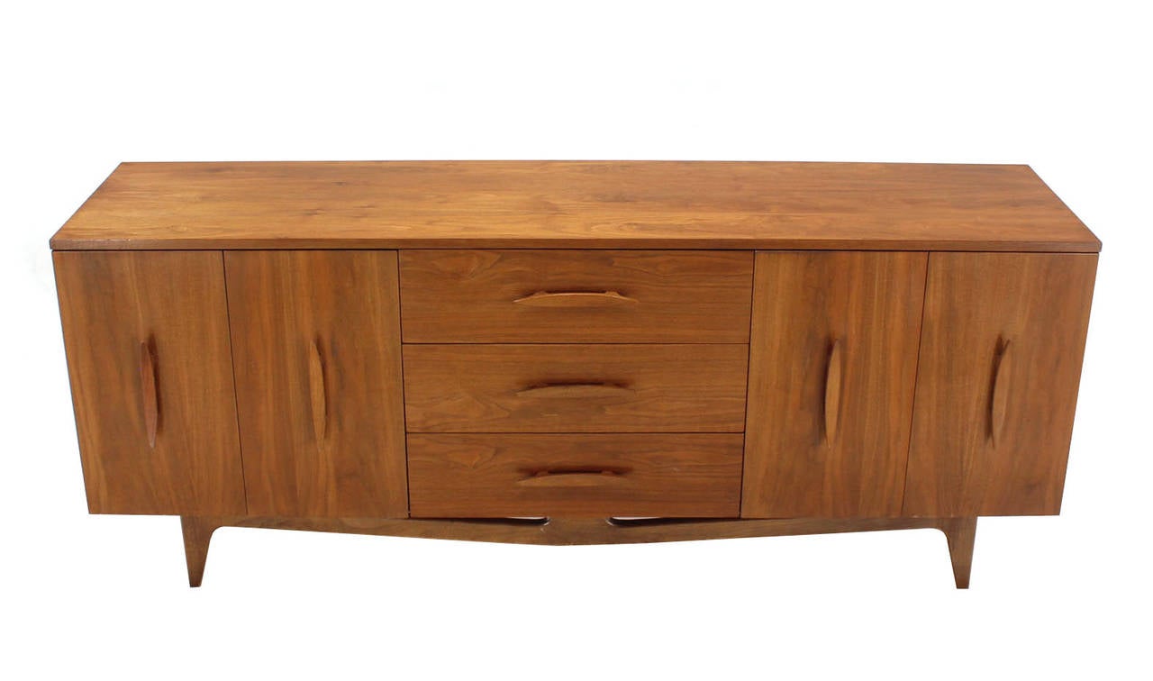 Mid century modern walnut dresser with folding doors in excellent condition with gorgeous walnut wood grain.