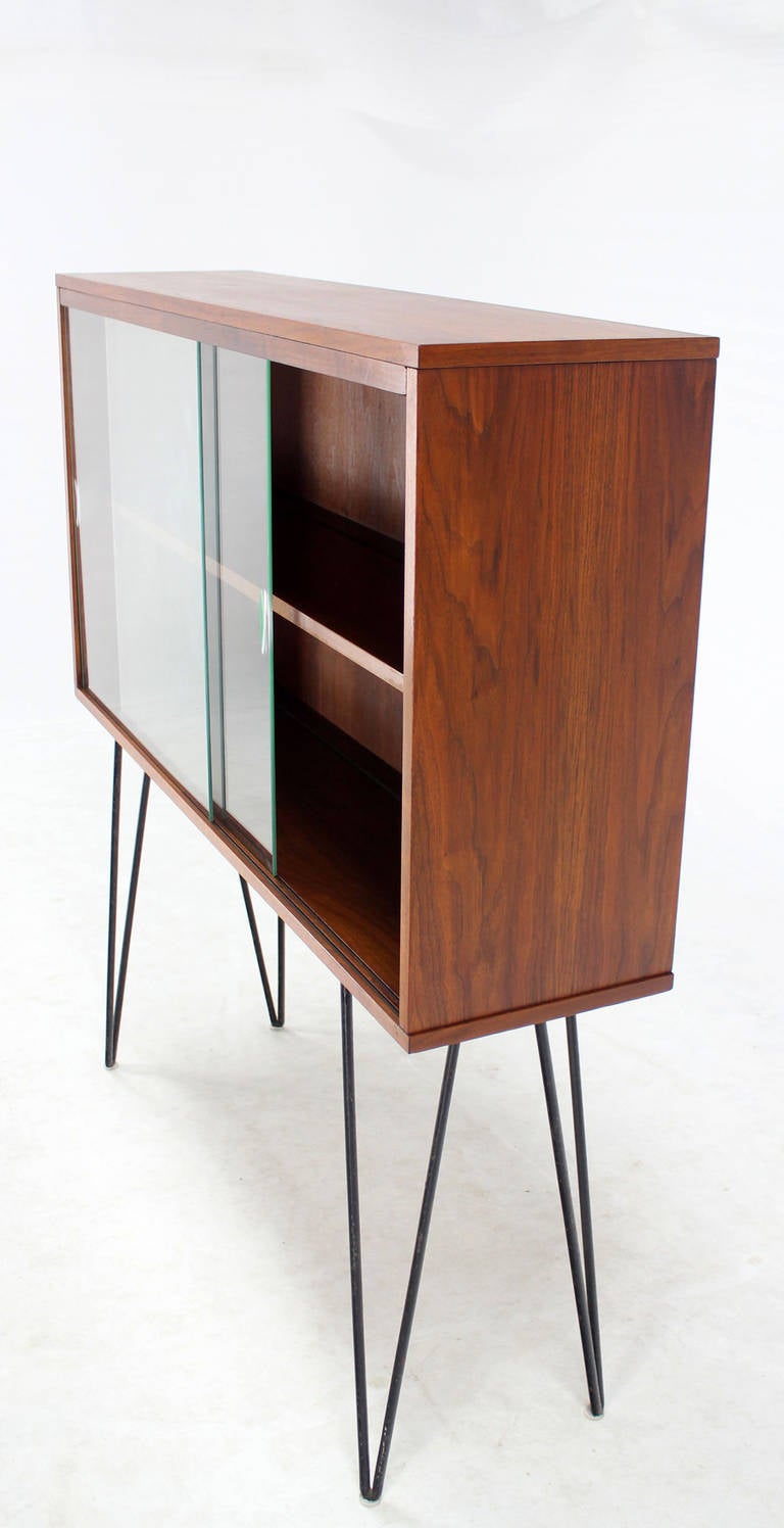 Very nice mid-century modern walnut bookcase on tall hairpin legs.