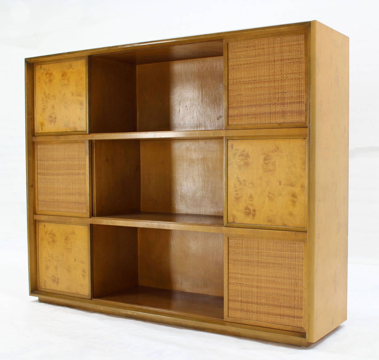 Very nice Swedish modern bookcase with multiple sliding doors by Edmund Spence. Blond birch wood with some burl elements and caned doors.