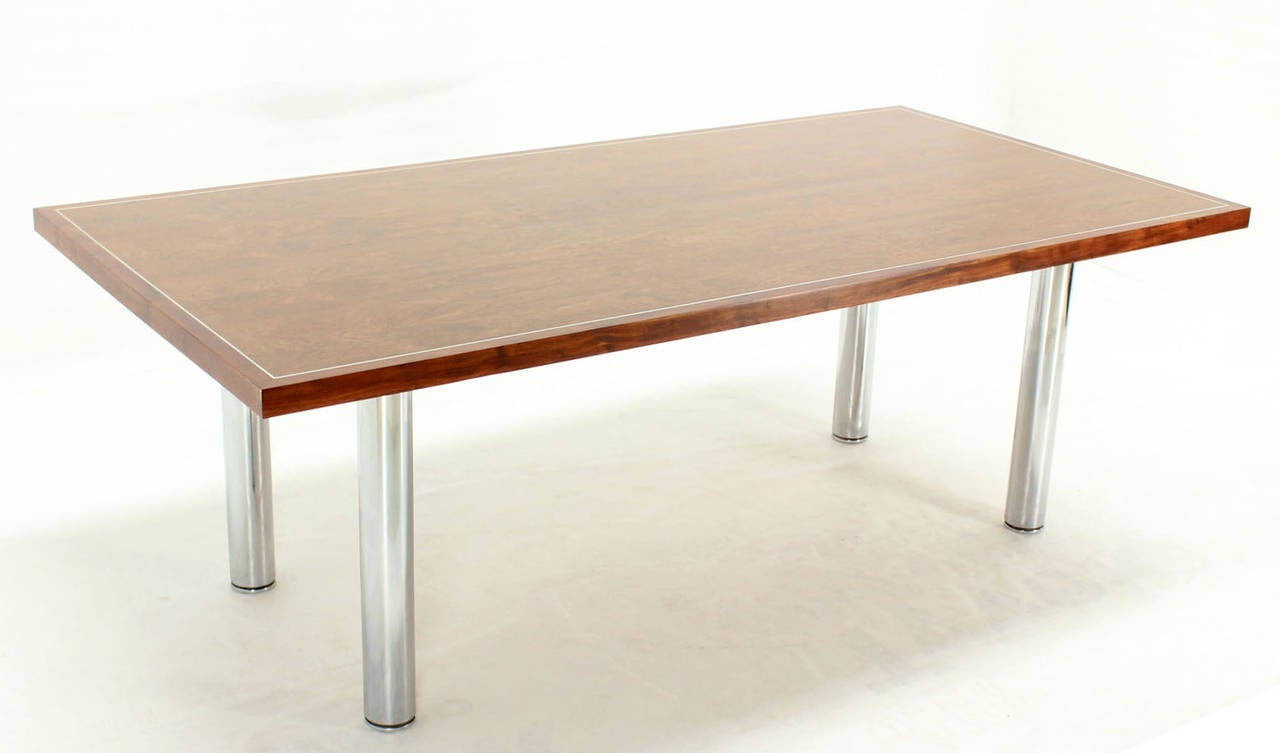Mid Century modern rosewood and chrome adjustable glides legs dining or conference table. Very beautiful rosewood grain top. High quality chrome legs.