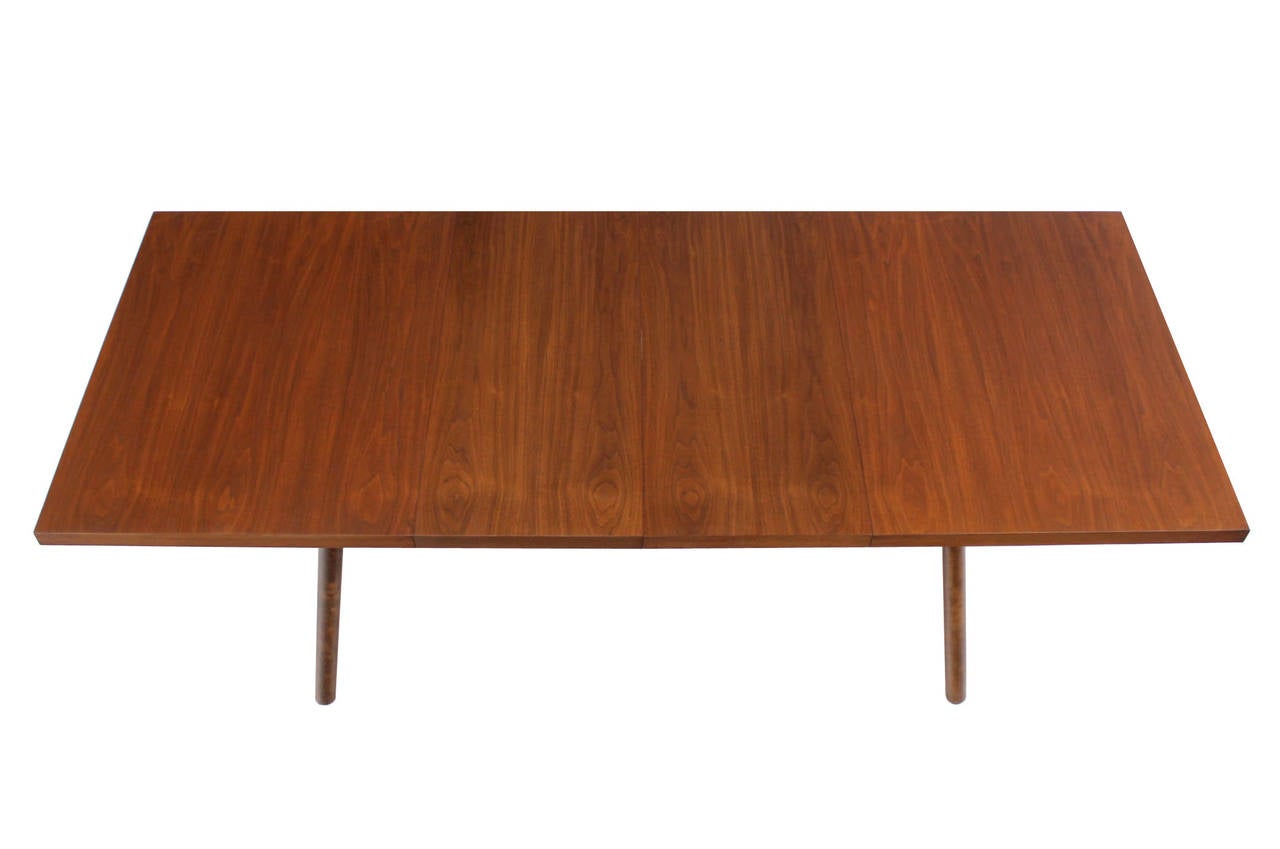 Very nice walnut dining table by Robsjohn Gibbings with two 2x18 Inches leaves.