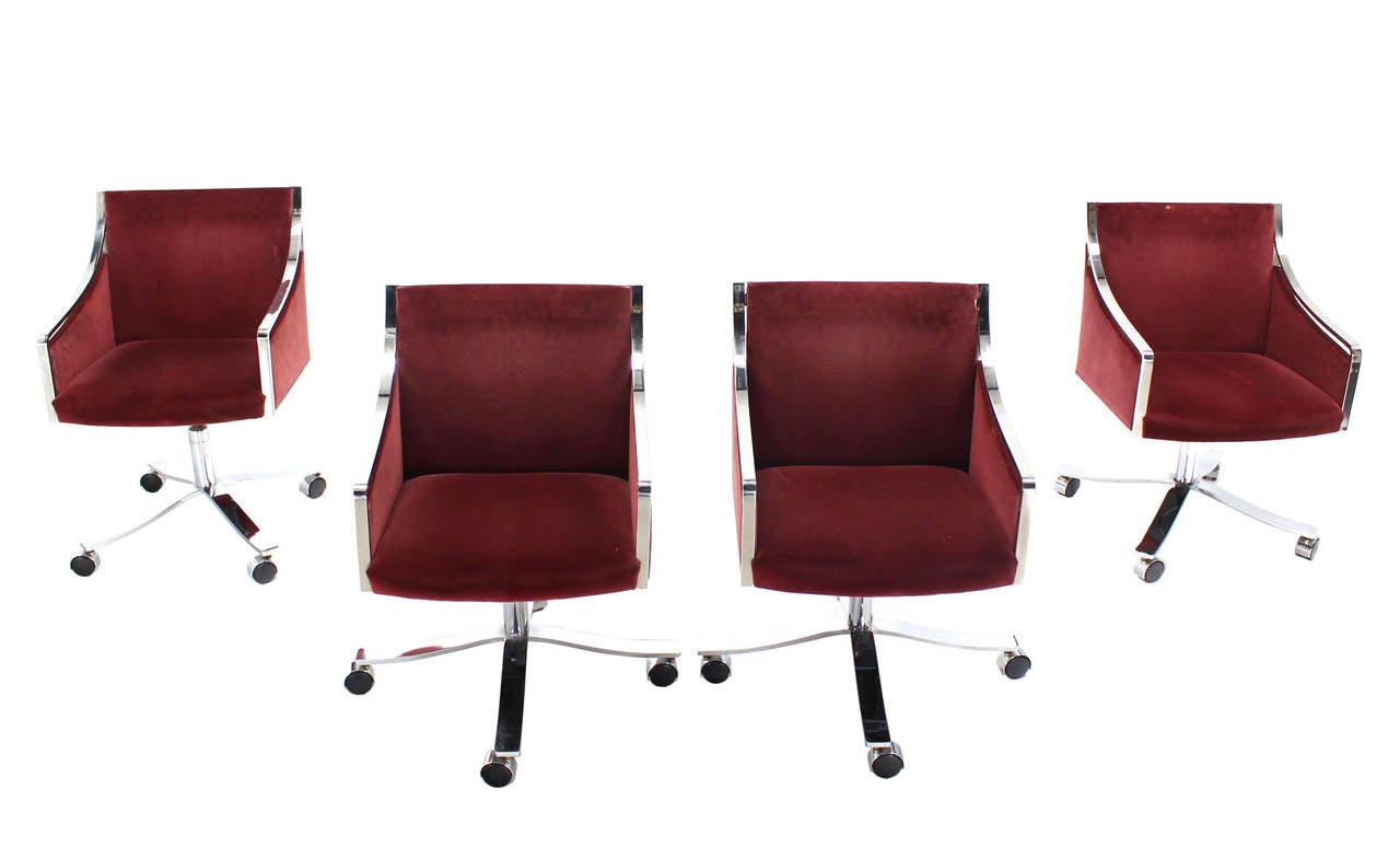 Set of four Mid-Century Modern office or desk chairs. The chairs are beautifully constructed of heavy gage welded and polished stainless steel bar.