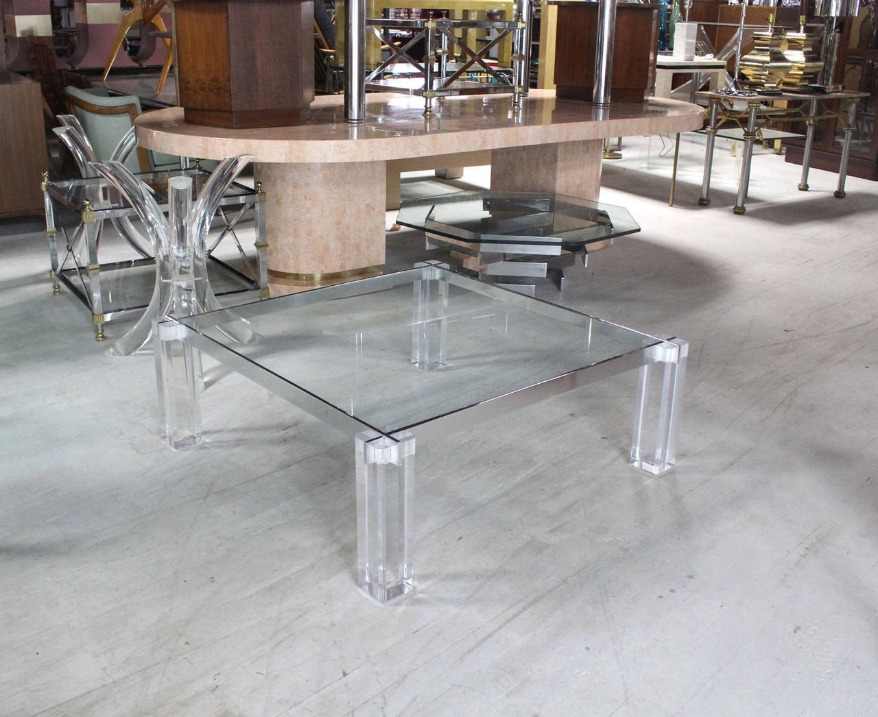 Lucite legs with interlocking stainless steel bars glass top coffee table.