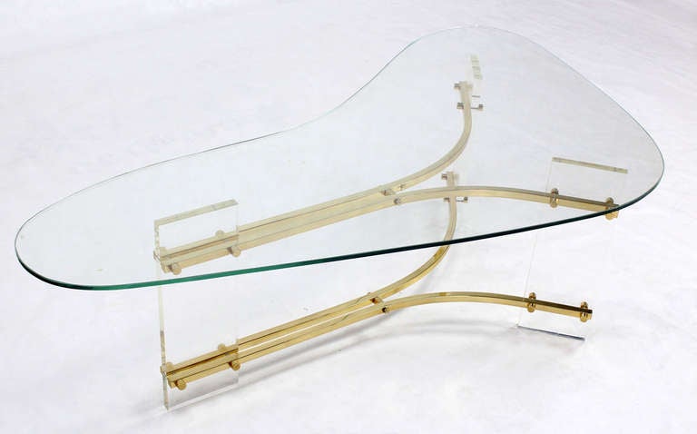 Very nice lucite and brass base kidney shape glass top coffee table. Excellent original vintage condition.