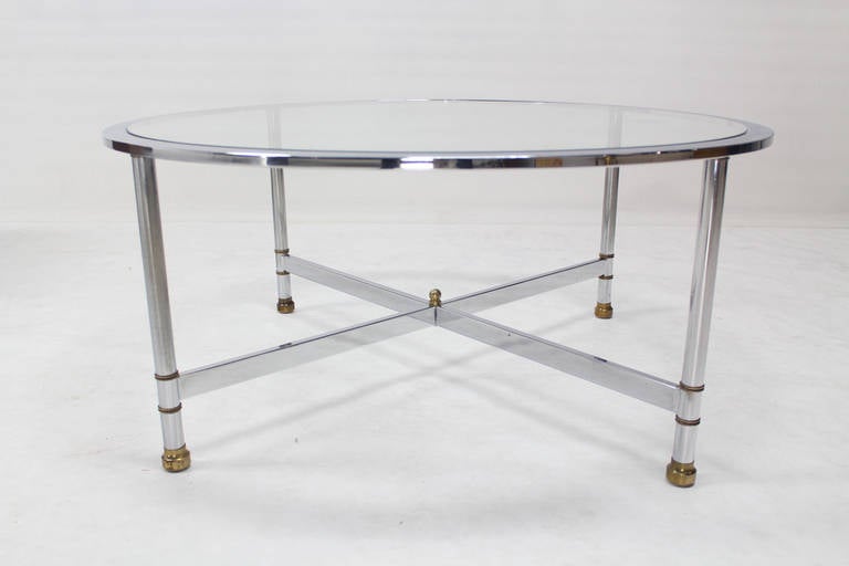 Nice mid-century modern chrome brass glass top round coffee table in style of Jansen.