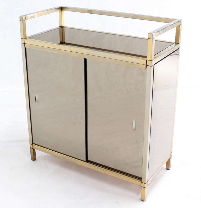 In Style of M. Baughman mid-century modern serving cabinet or bar with sliding doors.