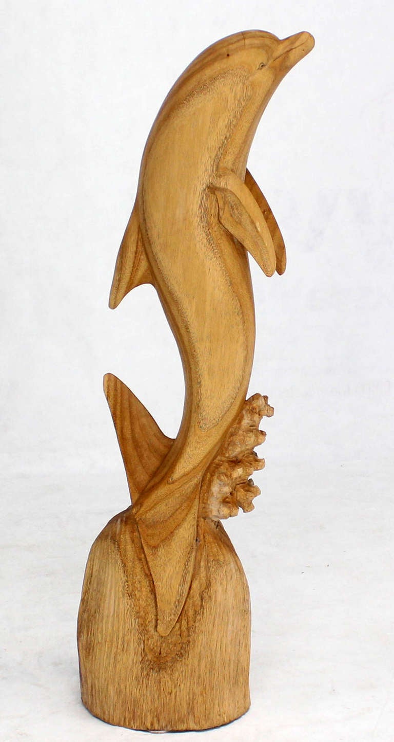 large wooden dolphin sculpture