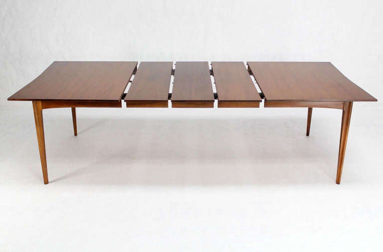 Very nice Danish modern walnut dining table w 3 leaves X12" each. The table features nice walnut wood grain with rosewood inserts.