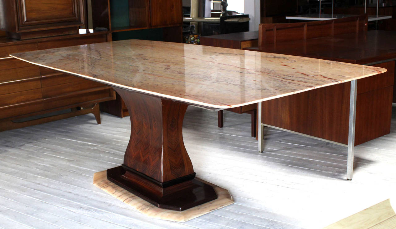 Outstanding Mid-Century Modern Art Deco inspired marble and rosewood pedestal base dining table with boat shape marble top.