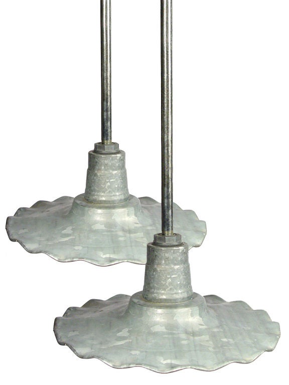 This is a matching pair of galvanized metal pendent lamps. This type of lamp was often found on train platforms from the 1920 - 1940. Most examples were painted tin... but these lamps are unique.  They were never meant to be painted and had a