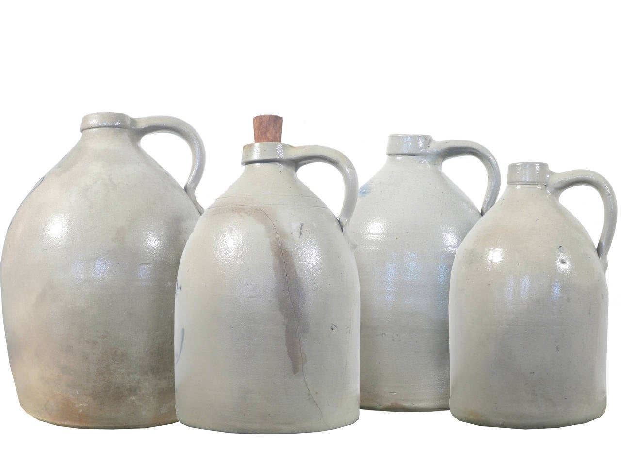 This is a nice collection go jugs. The blue decoration on these are clear and elaborate. Designs include a butterfly, bird, flower and leaf. These are really good examples of this type of early jug. They range in size from 16, 14, 13 and 12 inches