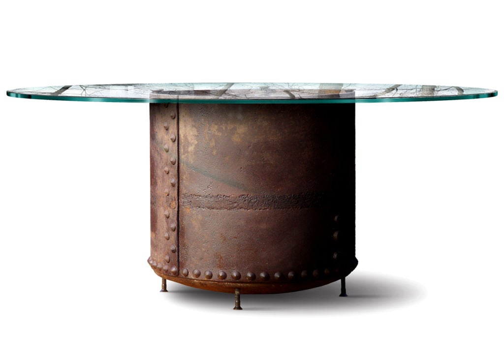 This table features a one-of-a-kind industrial base. We discovered this amazing hand-wrought and riveted tank hidden away in the woods behind a old barn.  It's early and I'd guess is at least 125-150 years old. We took a close up picture of the