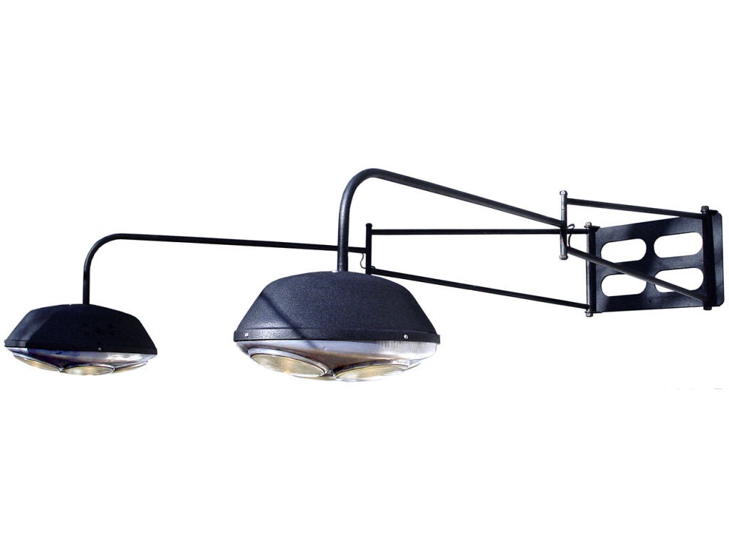This lamp is truly outstanding. It has 2 arms that each swing out from the wall over six foot in all directions. At the end of each articulated arm is a matching oval fixture. The lights have a striking futuristic look and are both cast aluminum