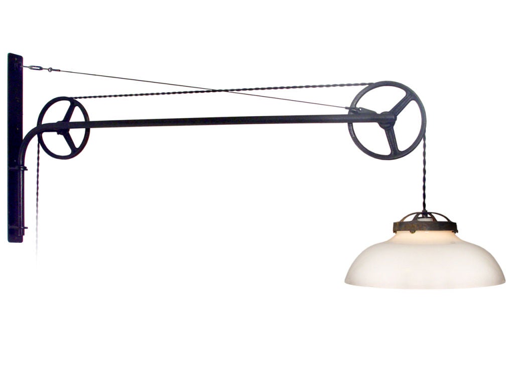 This striking double pulley lamp extends from the wall 58