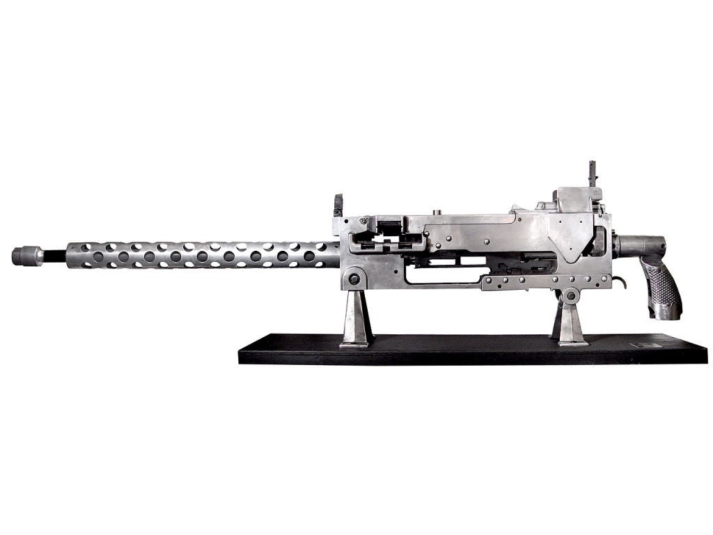 Oversized WWII era cut-away training model of the Model 1919 Machine Gun with an overall length approximately 76 inches. The display is made of aluminum and sheet metal and shows all working parts in detail. It has folding raised front and rear