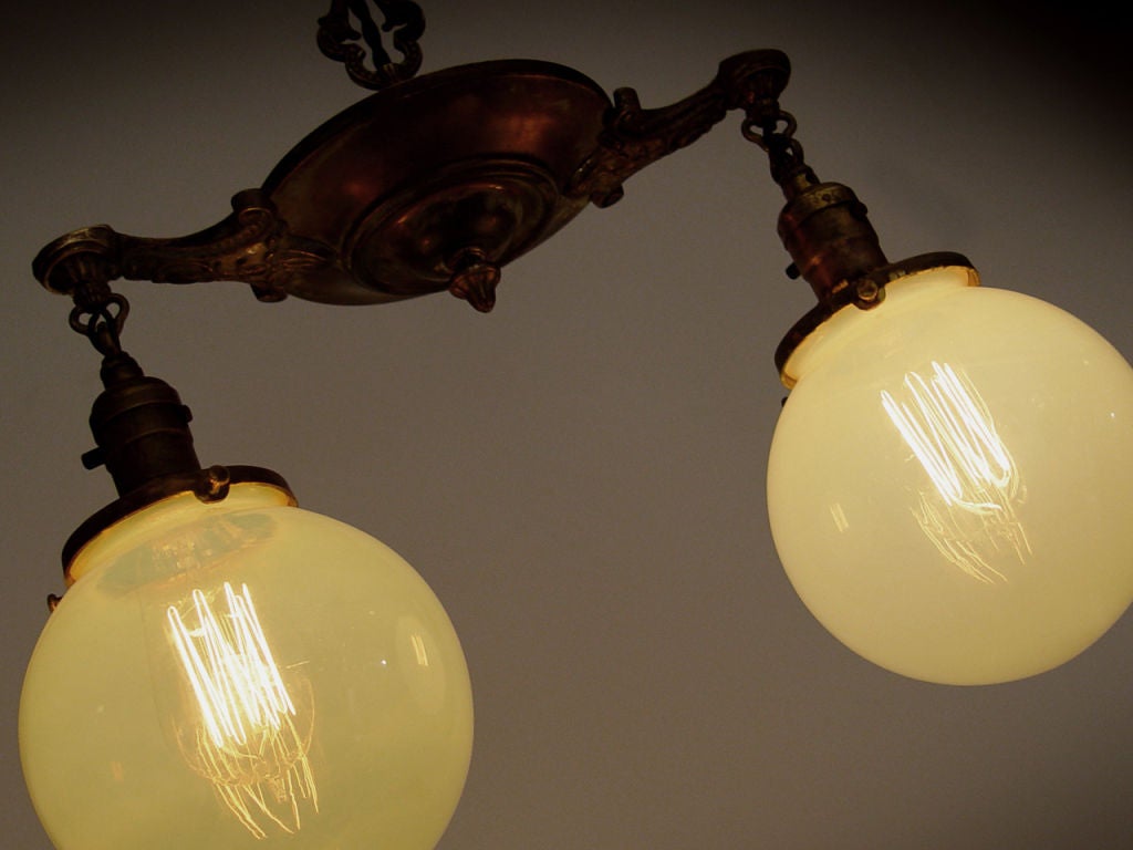 If you've been to New York's Park Avenue Armory this is the type of globe you'll see lighting their entrance halls. This simple 2 light fixture is all brass with some very nice detail. The decorative elements are not overdone and all the metal parts