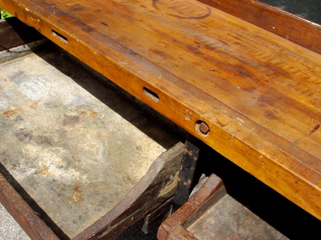 The generous proportions of the table and tin lined draws say potting bench.... but the details say it was used by a jeweler. That little wood and iron tool clamped to the table top is the kind used in jewelry making. Even the holes at the bench