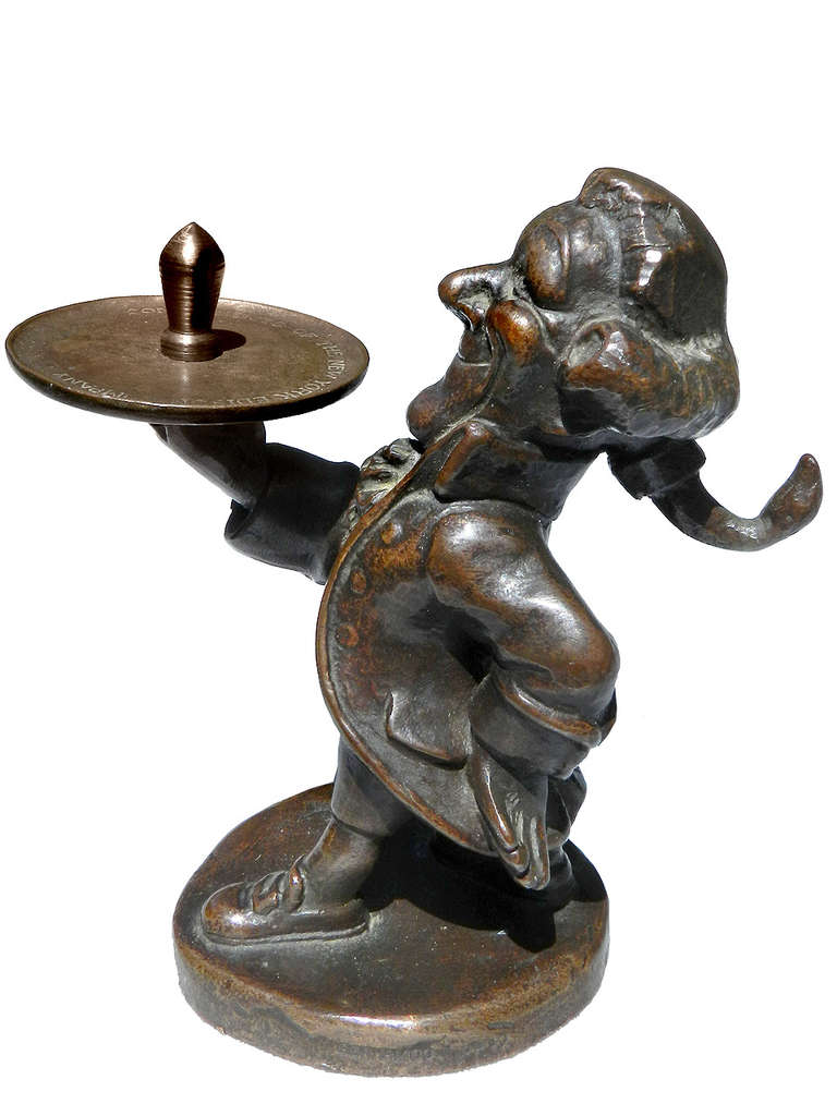 This Bronze figure statue was ring holder cast by Gorham for The New York Edison Company.  Cooper's iconic Colonial butler figure holding a tray with a single light bulb, the base engraved with... Compliments of The New York Edison Company... and