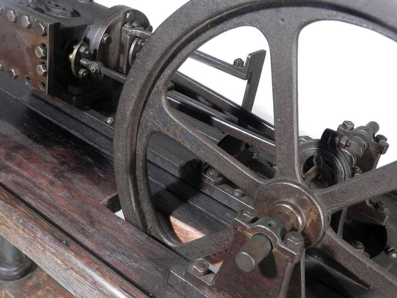 This is a nice size tabletop steam engine. It measures over two foot long. What I like best about it is the table it mounts to. The wood has an amazing patina and the pedestal legs and arms are cast iron. We found this on in Paris 20 years ago.