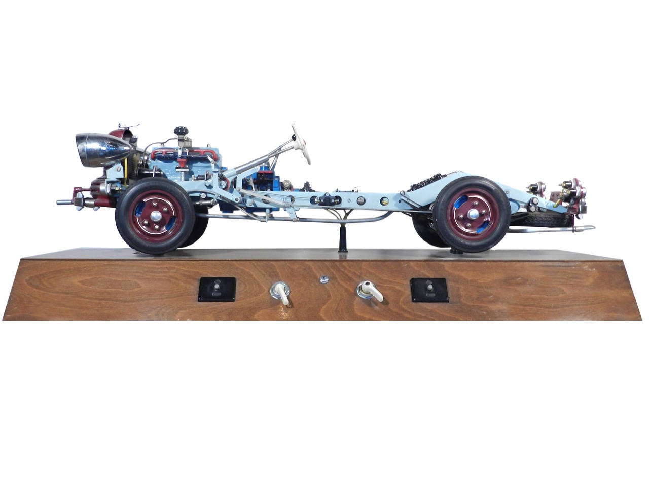 A striking example of a rare pre WWII instructional auto model made by HOHM Modelle Co. It is fantastic in both detail and execution. 42' overall, all metal, with cutaways of the working transmission, driveshaft, and rear end. It has head lights and