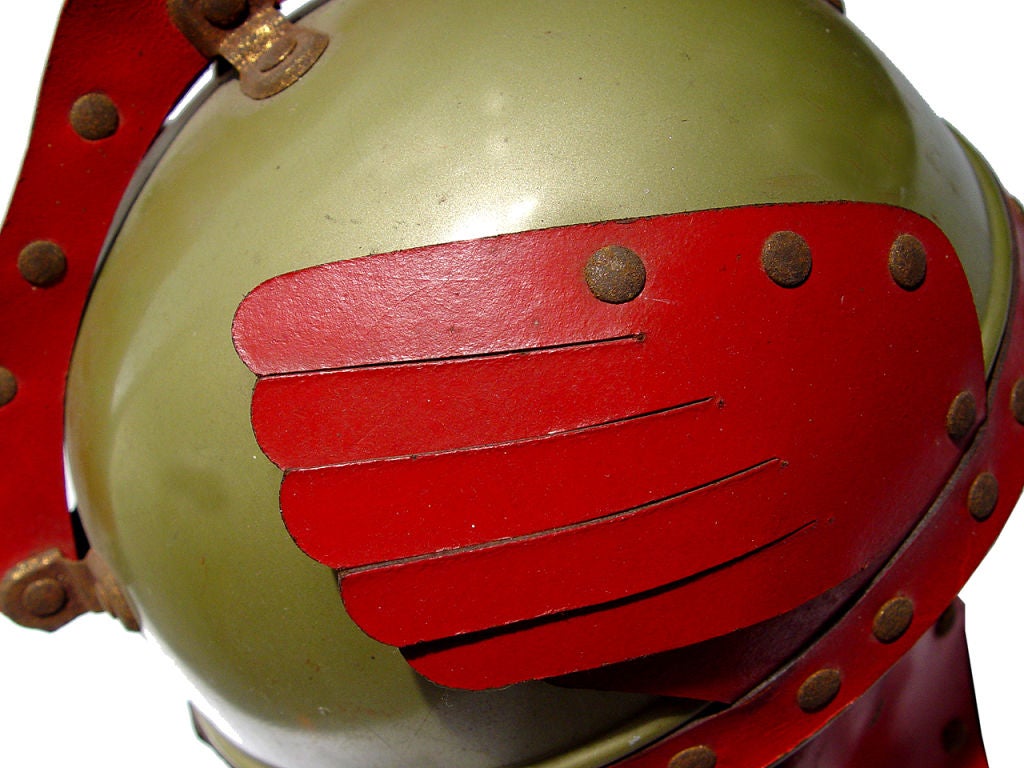 This early child's space helmet has just the right look. Green painted cap with amazing red leather details. It dates to TV and radio's science fiction golden age. It's in excellent original condition an comes with a custom made museum style display