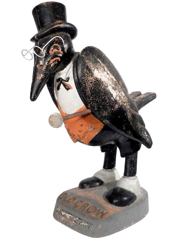 This is an early 20th Century Old Crow Bourbon display figure. It's composition with the original paint. It's unrestored and has a beautiful weathered patina. I'm told that this is the largest example they made. It stands over 26 inches tall and has