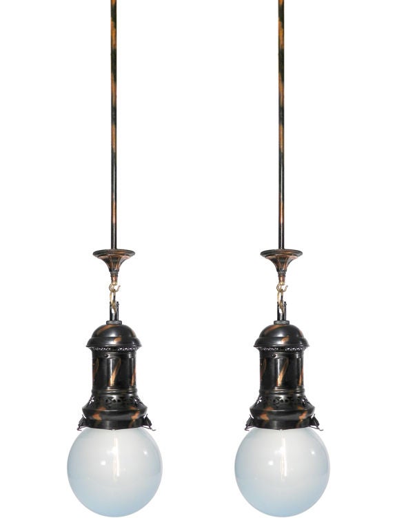 This is a spectacular pair of Japanned light fixtures in excellent, working condition. They feature metal fitters with copper and black Japanned or Tiger Stripe patinaed fitters and gorgeous rare soft blue glass globe shades. Patent stickers on the