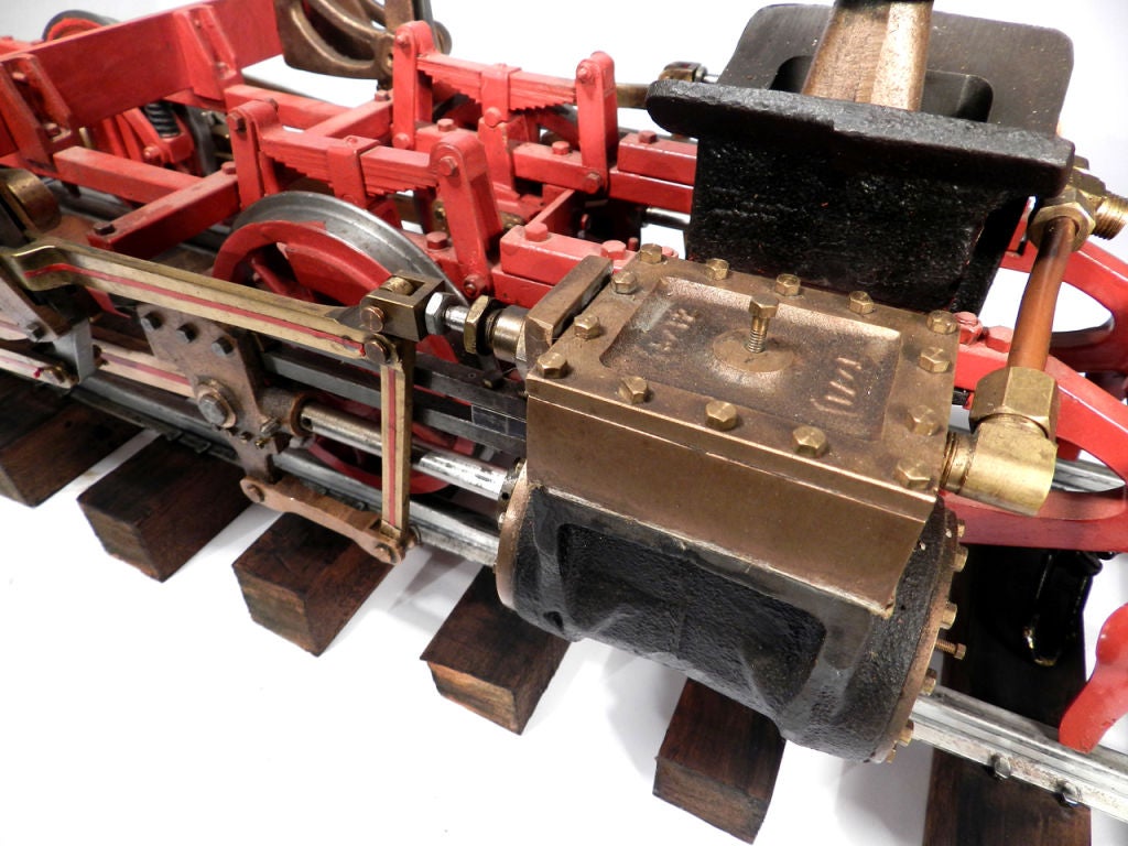 This is a beautiful as well as functioning brass steam engine chassis model. We hooked it to an air compressor and the twin steam engines ran smoothly. The model measures an impressive 36 inches long and 10.5 inches wide and sits on 44 inches of