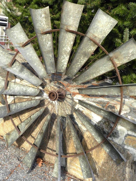 This complete set of windmill blades are a perfect example of American ingenuity at it's best. Take a closer look at the ring and hub. The 15 galvanized blades were build around the front wheel spokes of an 1800s High-Wheel bicycle. It perfect as a