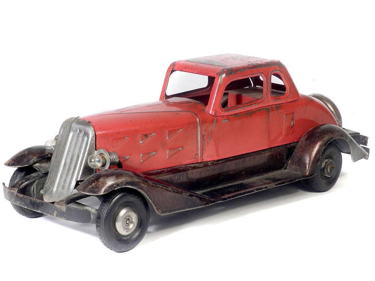 This beautiful pressed steel car measures an impressive 14.5 inches long and was made in the 1930s by Hoge of New York. In the 1930s this was the to every one wanted. The condition is that of a well played with toy. Most of the red and black paint